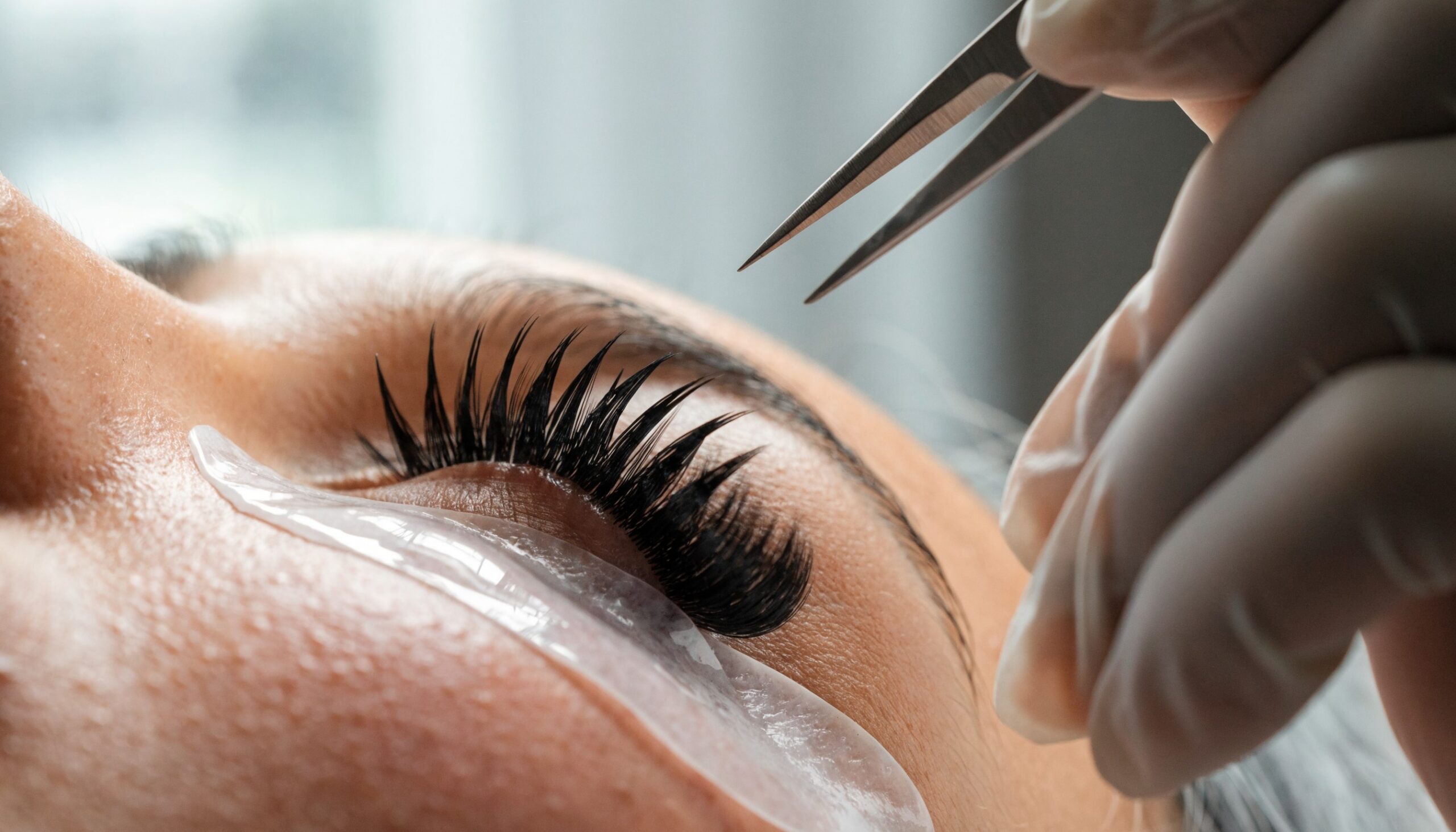 Texture Lashes: texturiertes Wimpernset mit Wet-Look-Spikes und weichen Layern, Lash-Stylistin mit Pinzette